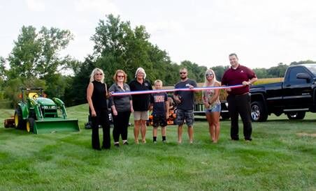 Veale's Mowing & More hold ribbon cutting
